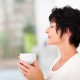 beautiful mature woman enjoying a cup of coffee at home